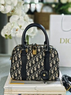 迪奥 新款 蓝色提花保龄球款 这款 D-Vibe 保龄球包是二零二四秋季成衣系列新品,款式简约时尚。采用蓝色 Oblique 印花面料精心制作,点缀以同色调皮革细节,搭配别具一格的皮革钥匙包,镌刻以 Christian Dior Paris 标志并点缀以金色饰面金属星星。随挂钥匙可打开拉链挂锁,宽敞的隔层设有一个插袋和一个拉链口袋,可收纳各种日常用品。中号款式,实用设计,搭配皮革顶部手柄和可调节、可拆卸的皮革肩带,可手提、肩背或斜挎。拉链开合,搭配镌刻以 Christian Dior Paris